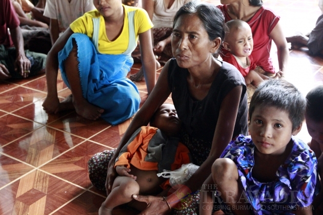 Myanmar policemen walk toward burning buildings in Sittwe, capital of Rakhine state in western Myanmar, where sectarian violence is ongoing, Tuesday, June 12, 2012. Myanmar policemen walk toward burning buildings in Sittwe, capital of Rakhine state in western Myanmar, where sectarian violence is ongoing, Tuesday, June 12, 2012.