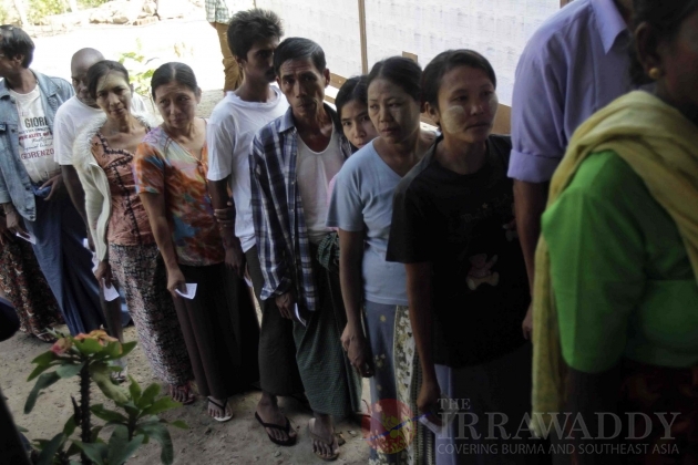 Voters make a line to register to cast their ballot at the poll station.