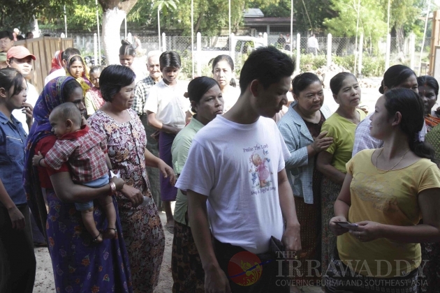 Voters make a line to register to cast their ballot at the poll station.