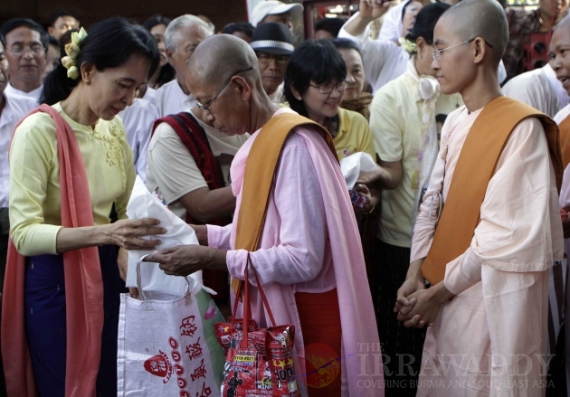 NLD leader Aung San Suu Kyi donates to nuns in Rangoon, Burma.
