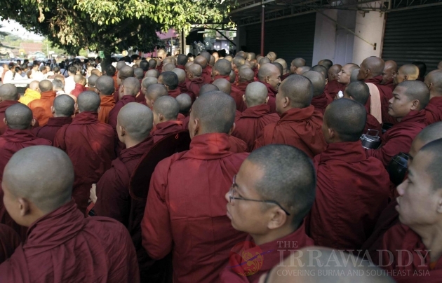 Buddhist Monks were waiting to receive alms from local people in Rangoon, Burma.