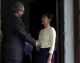 Burma pro-democracy leader Aung San Suu Kyi greets Mr Vijay Nambiar in front of her house in Rangoon, Burma.