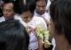 Burma pro-democracy leader Aung San Suu Kyi receives flowers from the local people.