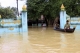 Two boats of flood victims float around the monastery in Bago division in Burma.