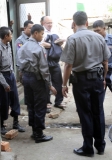 Burma policemen escort Ross Dunkley, founder of the English-Language Myanmar Times, as he leaves Kamayut township court after hearing in Rangoon, Burma. Dunkley has been held in Rangoon's Insein Prison since his February 10 arrest for allegedly overstaying a visa.
