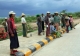 Daily waged workers gather on a road in Nayphitaw, the capital in Burma.