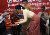 Burma pro-democracy leader Aung San Suu Kyi donates cash to family members of political prisoners during a ceremony of donation cash to family members of political prisoners at NLD party's headquarters, in Rangoon, Burma.