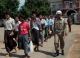 Prisoners walk out the Burma's Insein Prison after they are released as the new government cut one year from their prison terms under a &quot;general amnesty&quot; programmed in Rangoon, Burma.