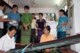 Saturday, Oct.22, 2011,  in Yangon, Myanmar- Myanmar democracy icon Aung San Suu Kyi visits a class of traditional hand weaving course organized by women members of her National League for Democracy party