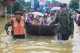 Myanmar military help transport local residents on a rubber boat through a flooded road after the Bago River swollen in Bago.