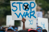 A signboard that requested to stop the wars at a marching ceremony celebrated in Yangon to honor the International Peace Day which falls on 21st September. (Photo – Sai Zaw/ Irrawaddy)