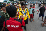 The supporters cheering for Myanmar National Football Team at Yangon International Airport on 8th September. Myanmar got a draw result when playing against the Philippines National Team at their home. Myanmar National Team became Champion with Soe Min Oo, the substitute player scored a goal during the extra time. (Photo – Sai Zaw/ Irrawaddy)