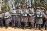 Police officers stand guard at a barricade leading to a monastery preventing the students from proceeding with a protest march to in Letpadan, March 2. 2015. ( Photo - JPaing / The Irrawaddy)