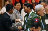 General Gun Maw, left, the KIA chief of staff, shakes hands with Lt-Gen Myint Soe, third left, as the government’s lead peace negotiator Aung Min, second left, looks on. (Photo: JPaing / The Irrawaddy)