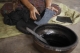 A female worker blackening the surface of a slate. (Photo: Tin Htet Paing / The Irrawaddy)