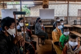 Migrants in the village near the Thai-Myanmar border have been affected by village lockdown, they are waiting for food handouts at the Parahita Htoo school in Phop Phra, Tak, Thailand, in May 2020.