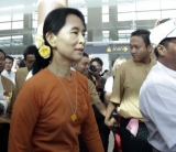 Burma's pro-democracy leader Aung San Suu Kyi lifts her son Kim Aris at the Yangoon international airport after he had spent with his mother for two weeks in Rangoon, Burma.