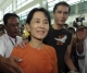 Burma's pro-democracy leader Aung San Suu Kyi lifts her son Kim Aris at the Yangoon international airport after he had spent with his mother for two weeks in Rangoon, Burma.