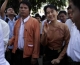 Pro-democracy leader Aung San Sun Kyi was greeting journalist during walk to headquarter in Rangoon, Burma.