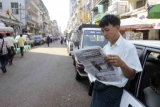 Publics follow up the news in Rangoon, Burma.
