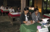 Couple teachers volunteer are sitting to bring out the ballots at the polling station.