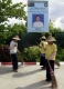 Cleaners clean the road in front of the U Myint Lin’s campaign poster, Union Solidarity and Development Party (USDP).