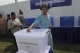 Shan lady delivers her vote in the ballot box in Nay Pyi Daw poll station.