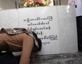 Burma pro-democracy leader Aung San Suu Kyi respects to her mother’s tomb, Daw Khin Kyi in Rangoon, Burma.