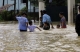 Parents took their children to cross flood.