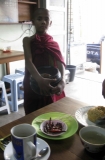 Young novice collecting alms at the coffee shop in Rangoon, Burma.