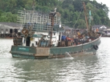 A fishing ship leave the port in Ranong, southern Thailand.