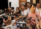 Burma pro-democracy leader Aung San Suu Kyi (right) is surrounded by the media after meeting with Vijay Nambiar a top aide to U.N. Secretary-General Ban Ki-moon, at her home in Rangoon, Burma.