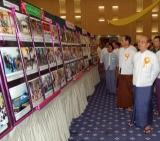Burma President Then Sein observes documentary photo as he attends the workshop on &quot;Rural Development and Poverty Alleviation&quot; in Naypyitaw, Burma.