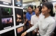 Burma pro-democracy leader Aung San Suu Kyi watches photos displayed at photo exhibition at her National League for democracy party's headquarters in Rangoon, Burma.