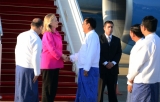 US Secretary of State Hillary Rodham Clinton waves alongside Myanmar Deputy Foreign Minister Myo Myint, left, upon her arrival by her airplane in Naypyidaw, Myanmar, Wednesday, Nov. 30, 2011. Making a diplomatically risky trip to the long-isolated Southeast Asian nation of Myanmar, Clinton said she wanted to see for herself whether new civilian leaders are truly ready to throw off 50 years of military dictatorship _ a test that includes rare face-to-face meetings with former members of the junta whose brutal rule made a poor pariah state of one of the region's most resource-ric