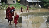 21-08-12 Delta flooding Young Monks wade through water after flooding in the Delta region of Burma