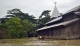 21-08-12 Delta flooding Residents paddle past a Christian church after flooding in the Delta region of Burma