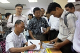 28-08-2012 Ko Ko Gyi book signing - PHOTO Jpiang Former political prisoner and Generation 88 leader, Ko Ko Gyi, (sitting on left) at his book signing