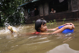 Children swiming on a flooded water in Hlegu at the Yangon region of Myanmar.