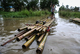 Children's paddles a makeshift bamboo raft on a flooded water in Hlegu at the Yangon region of Myanmar.