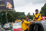 The role cars that carried Myanmar National Football Team, the champion of Philippines Peace Cup on Pyay Road. Myanmar got a draw result when playing against the Philippines National Team at their home. Myanmar National Team became Champion with Soe Min Oo, the substitute player scored a goal during the extra time.   (Photo – Sai Zaw/ Irrawaddy)