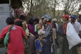 The following is the photos captured on March 22, 2013. The communal violence which broke out on March 20, 2013 left at least 40 people dead and forced hundreds from their homes following arson attacks.  policeman holding a victim baby.(Photo - teza hlaing / The Irrawaddy)