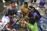 Local men and women prepare food to be shared with other worshippers. (Photo: Teza Hlaing / The Irrawaddy)