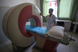 A technician shows an MRI machine at a Wa Special Region government-owned hospital in Panghsang. (Photo: JPaing / The Irrawaddy)