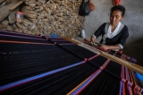 An ethnic Wa woman weaves traditional textiles in Panghsang. (Photo: JPaing / The Irrawaddy)