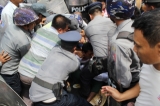 Police forcibly detain labor rights protestors in Tatkon Township on May 18, 2016. ( Photo - Thiha Lwin / The Irrawaddy )