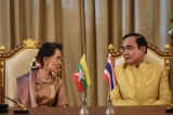 Myanmar's foreign minister and state counsellor Aung San Suu Kyi (L) aund Thailand's Prime Minister Prayuth Chan-Ocha (R)  make a toast during a MOU ceremony at government house in Bangkok ,Thailand, June 24, 2016. ( Photo - JPaing / The Irrawaddy )