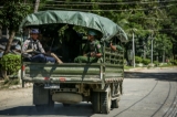 Armed military and police force travel in trucks through Maungdaw, located in Rakhine State, on Oct 17, 2016.