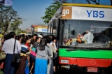 As Monday, Jan. 16 marks the first day of Yangon Bus Service operations, commuters wait to board the new downtown bus line in the transit area near Thakhin Mya Park. (Photos: Pyay Kyaw / The Irrawaddy)