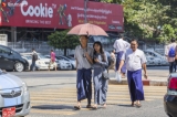 People cross the road near downtown Yangon under the scorching sun of spring on February 11, 2019.  Photo - Htet Wai/ Irrawaddy